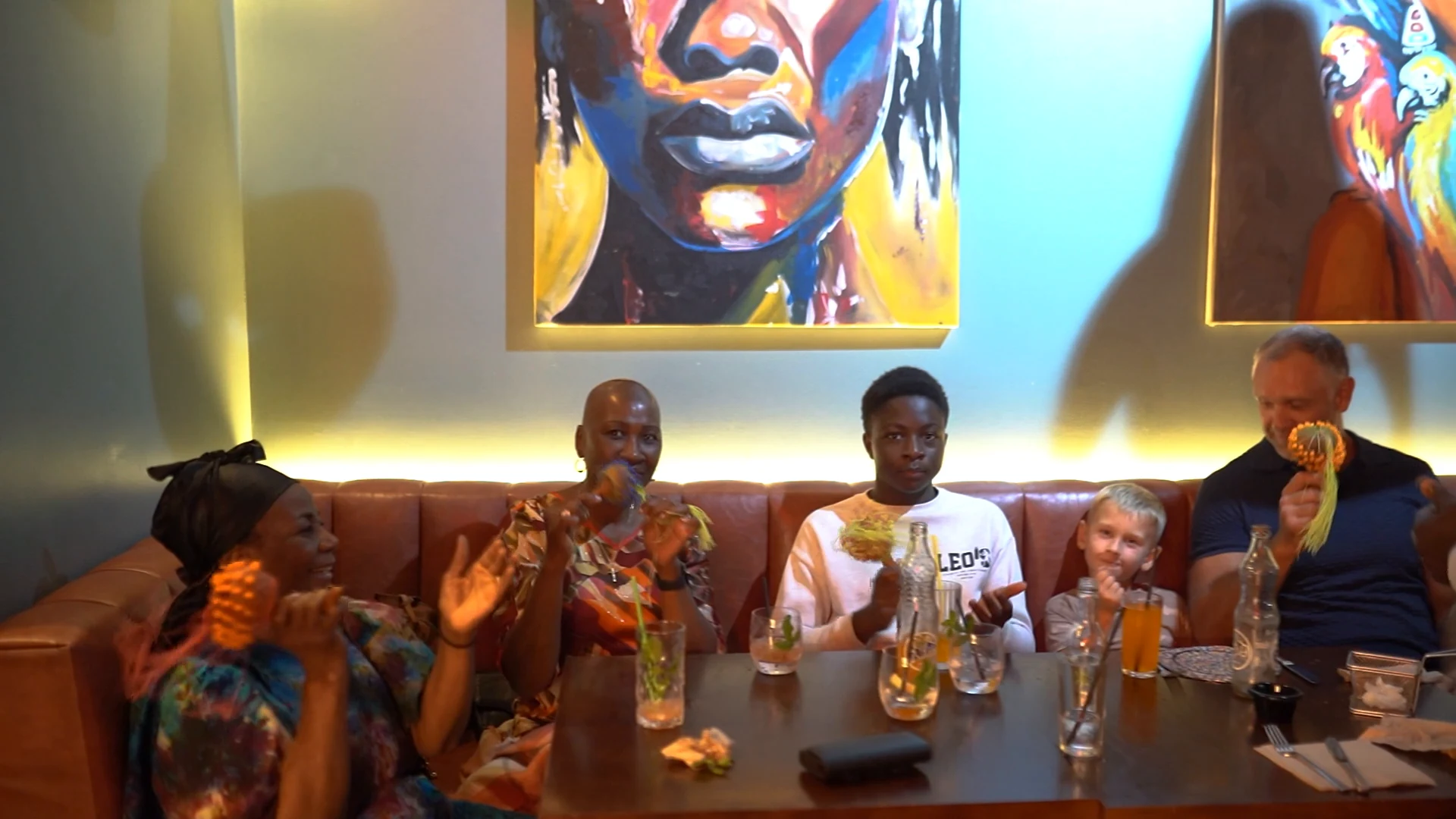 Guests raising drinks around a table