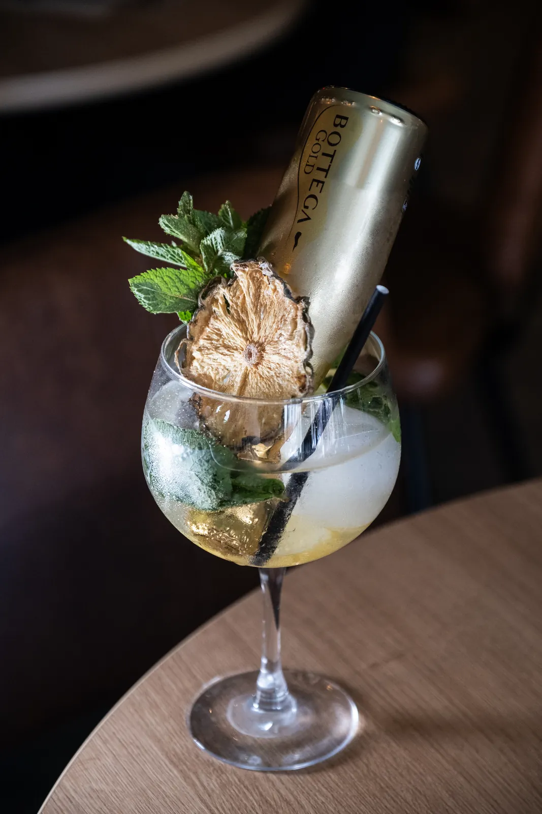 A pale cocktail with fresh garnish
