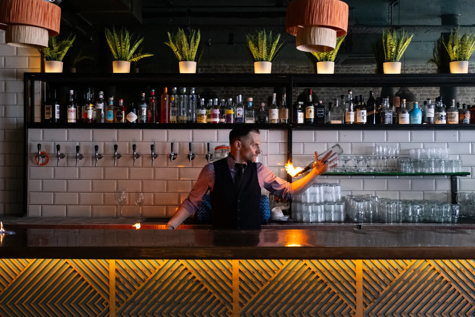 A bartender performing behind the bar