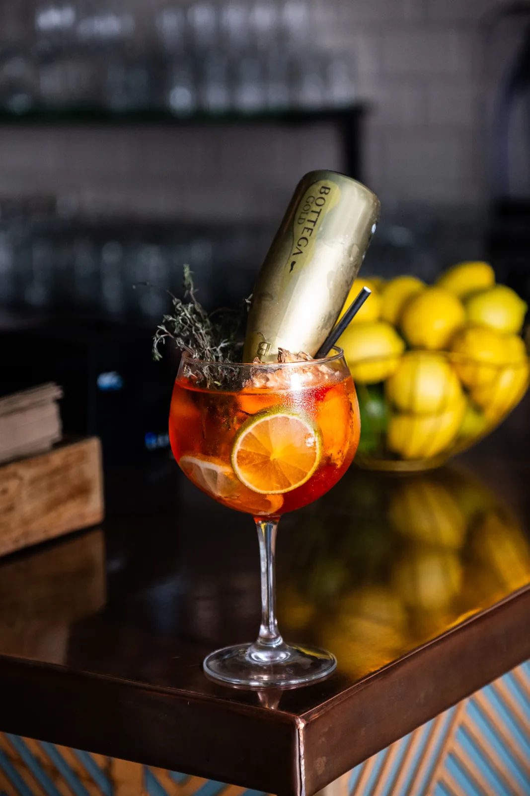 An orange cocktail against the Monika bar