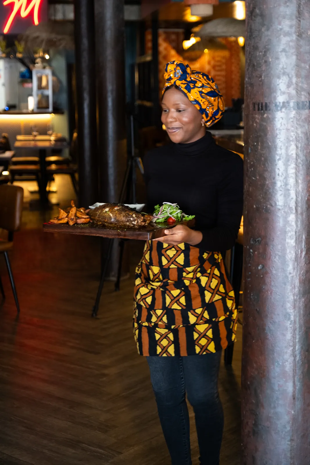 A member of the team bringing food to the dining room
