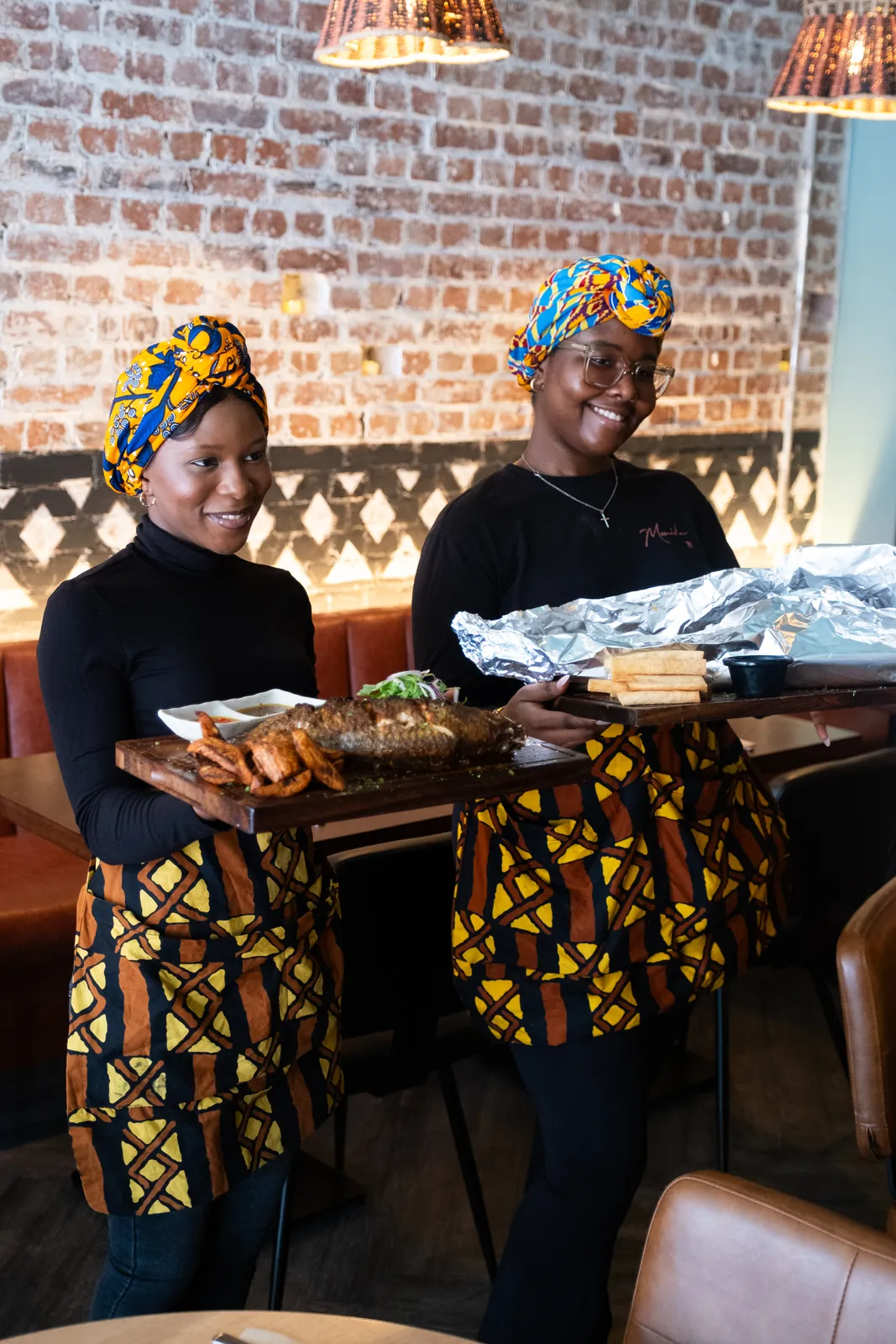 Two members of the team serving sharing dishes