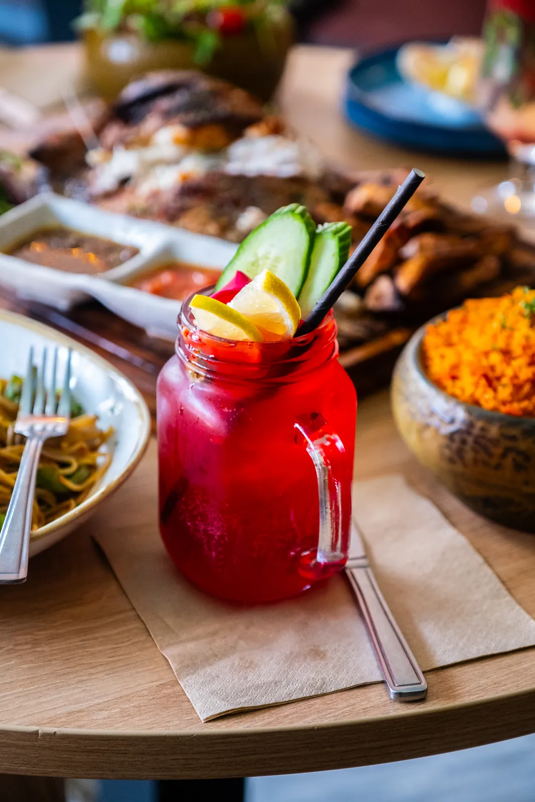 A red cocktail with mint and fruit