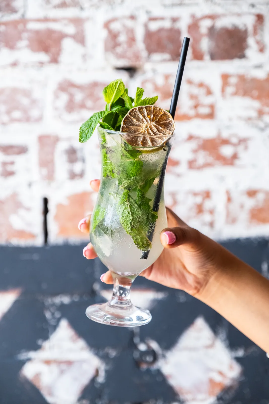 A green cocktail with lime and mint