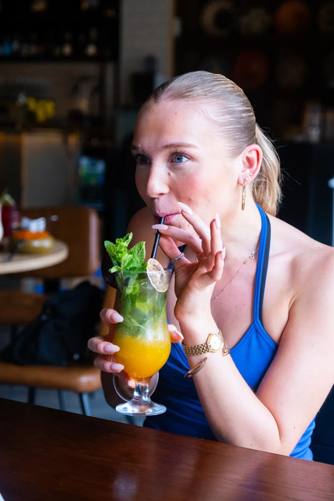 A guest enjoying a cocktail and conversation at Monika