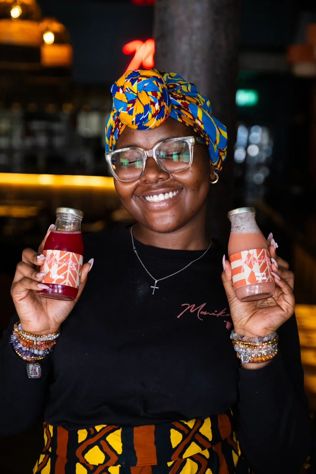A smiling member of the Monika team with drinks