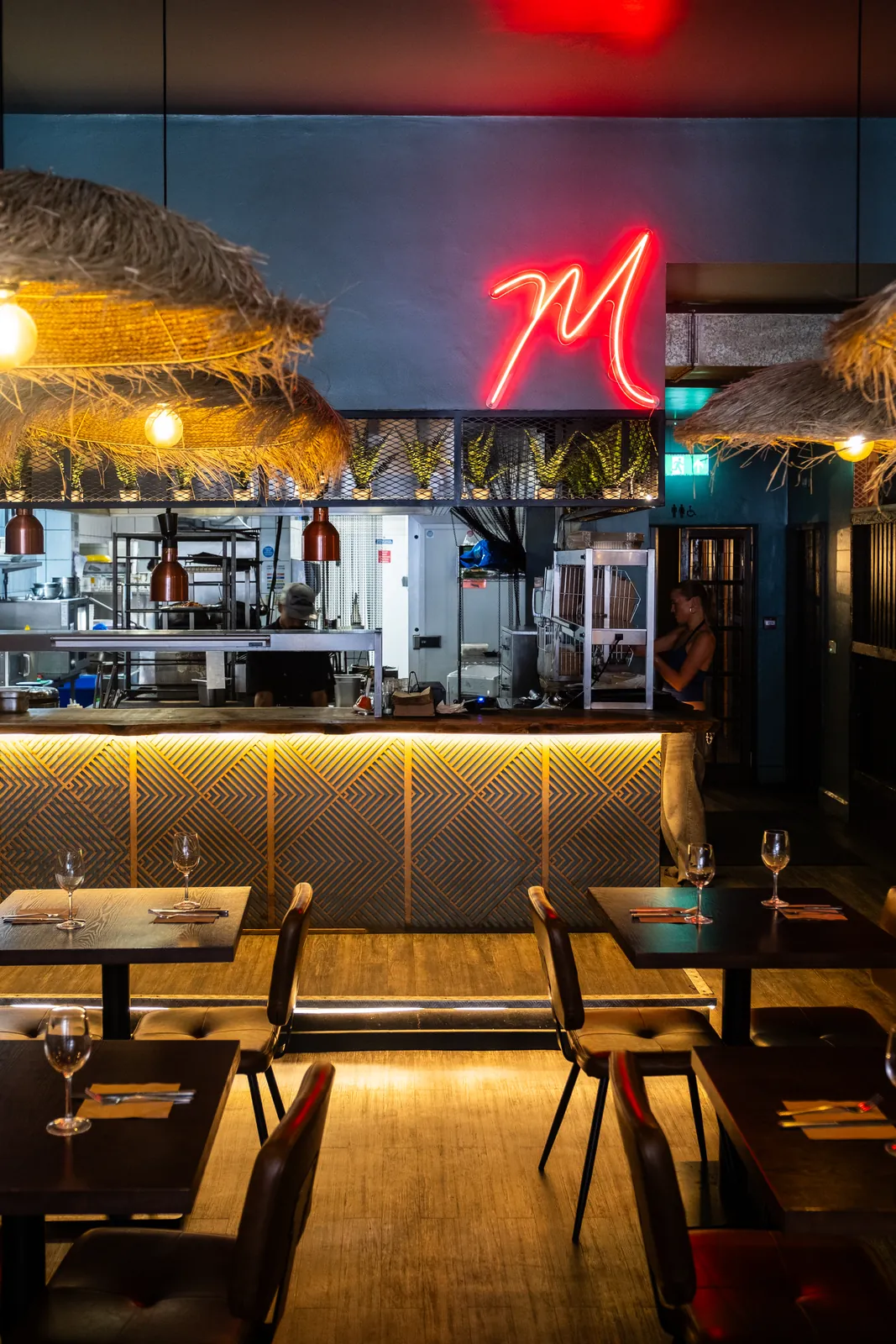The illuminated Monika sign above the bar