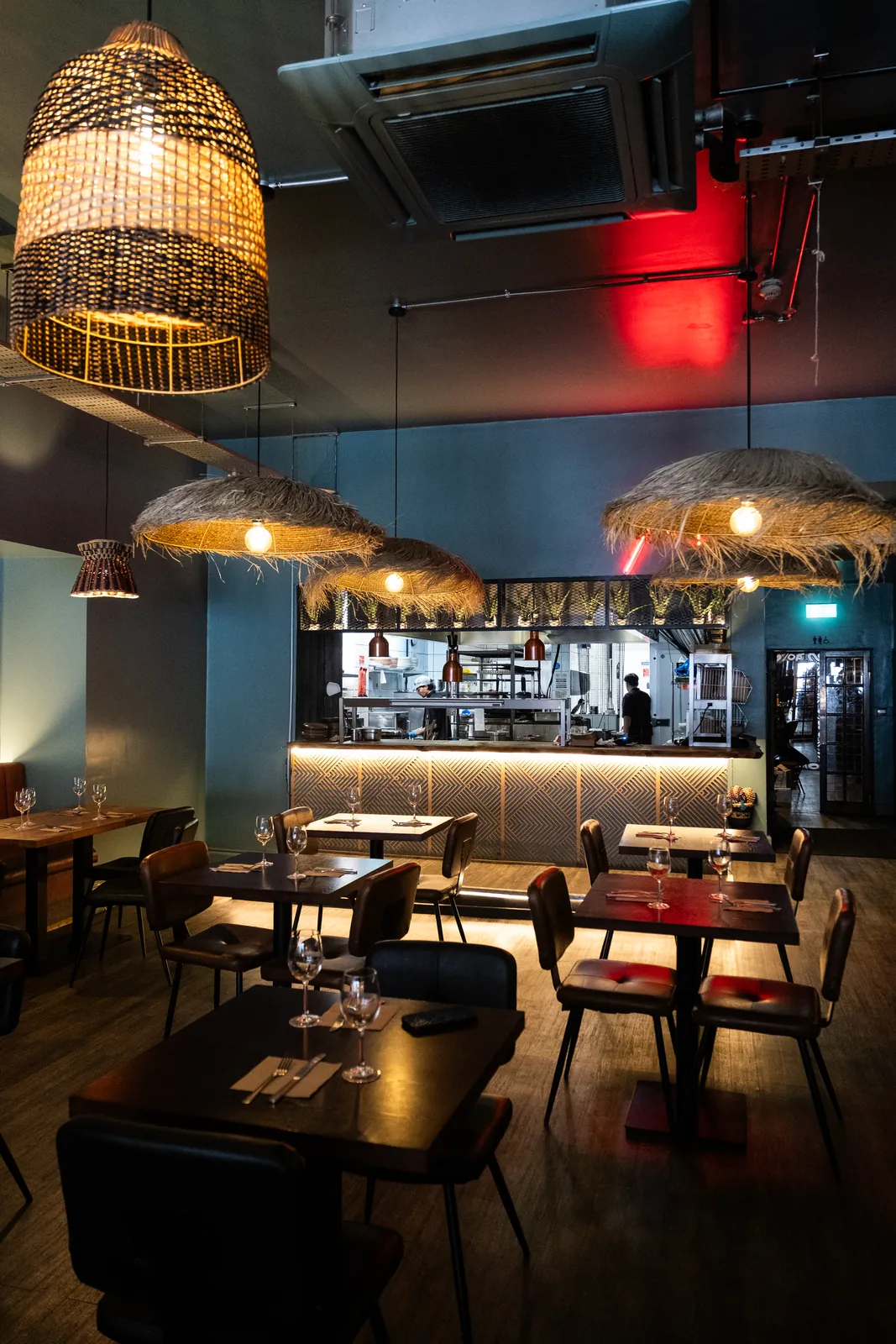 Tables and woven lights in the Monika dining room