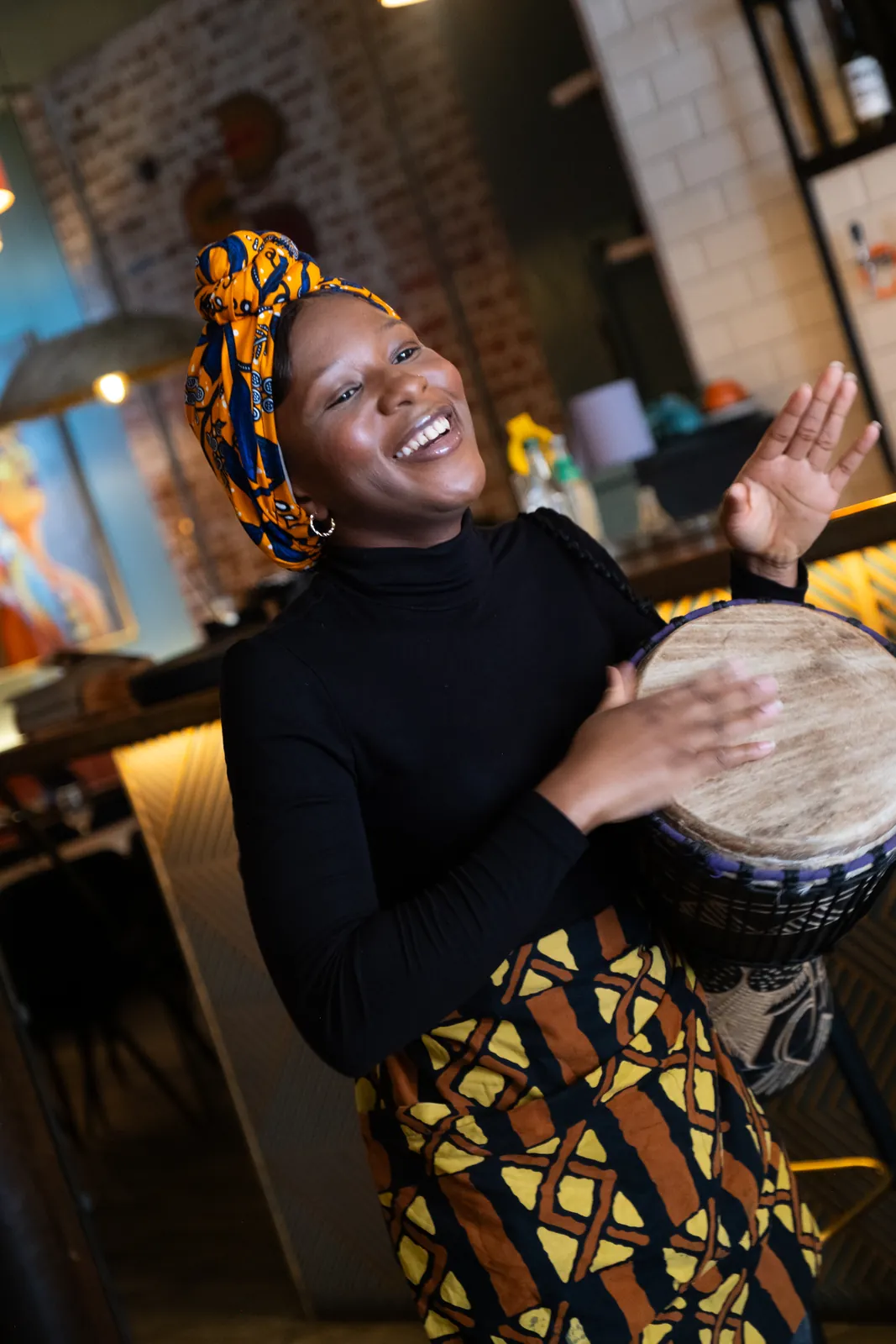 A member of the Monika team playing a hand drum