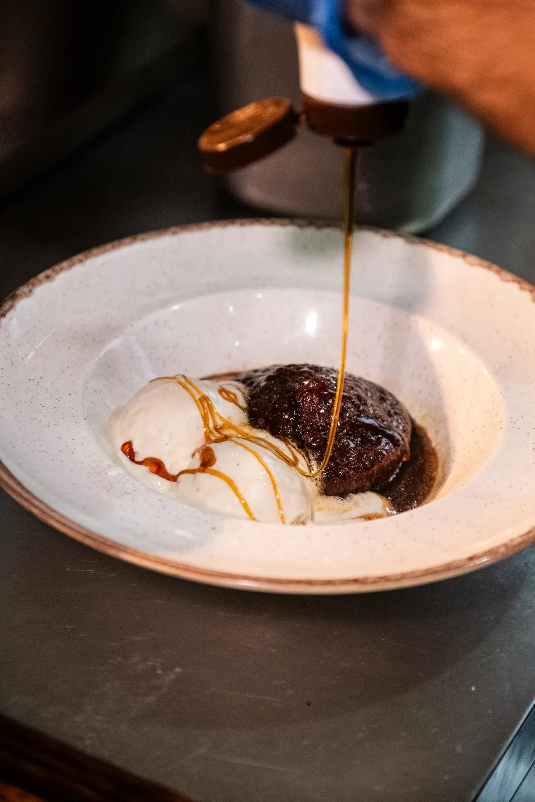 Sauce poured over a plated dessert