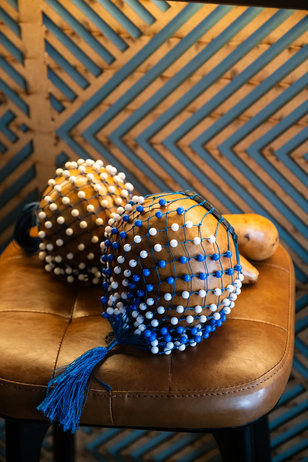 Beaded percussion instruments beside the bar
