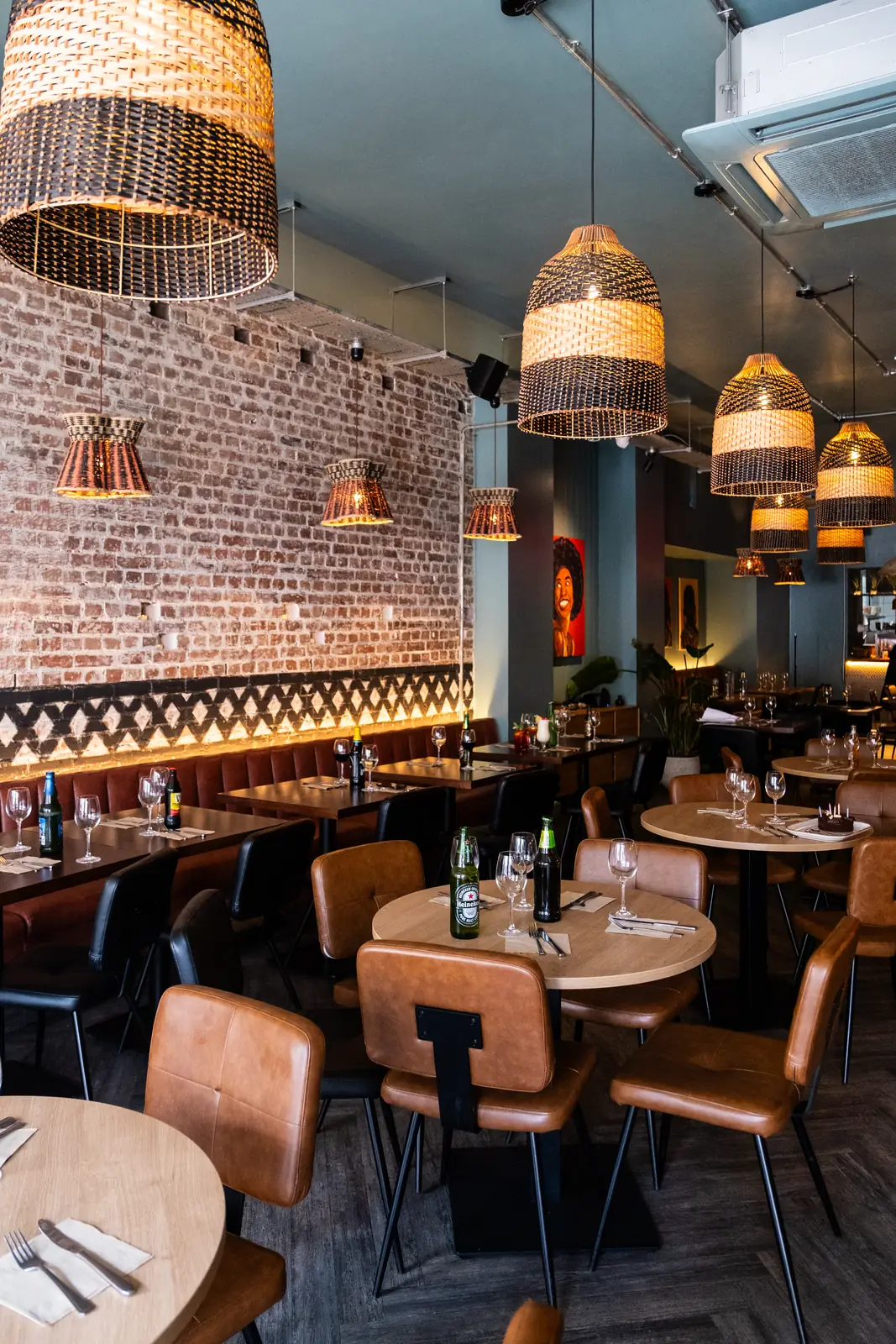 The dining room with exposed brick and woven lights