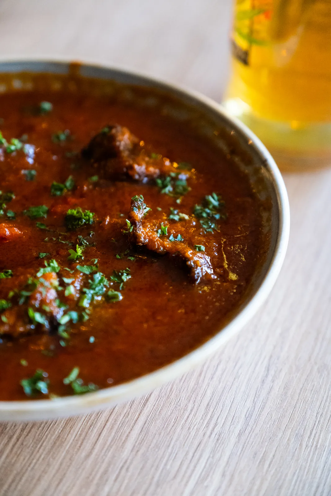 A richly coloured dish with fresh herbs
