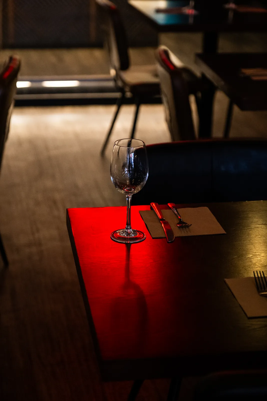 A table beneath the glowing Monika sign