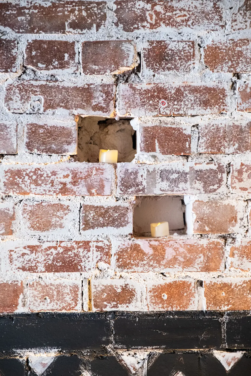 Candlelight set into the exposed brick wall